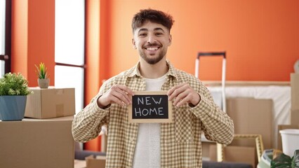 Sticker - Young arab man smiling confident holding blackboard at new home