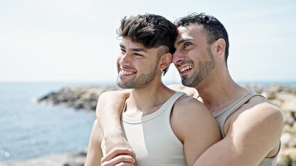 Poster - Two men couple smiling confident hugging each other at seaside