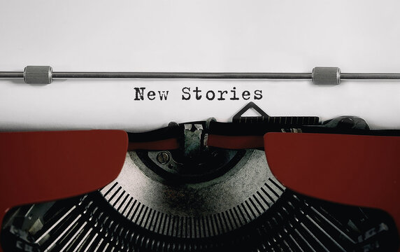 Text New Stories typed on retro typewriter