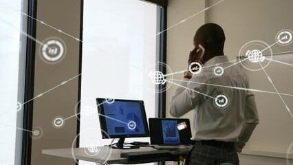 Poster - Animation of network of digital icons over african american businessman talking on smartphone