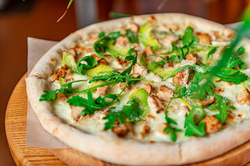 Wall Mural - Delicious pizza with grilled chicken, avocado, and arugula.