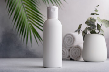 White blank packaging cosmetic plastic bottle with palm leaves