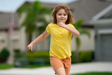 Canvas Print - Morning running jogging with children. Child runner jogger running in the nature. Active healthy kids lifestyle. Sporty kid running in street. Sporty child boy runner running in park.