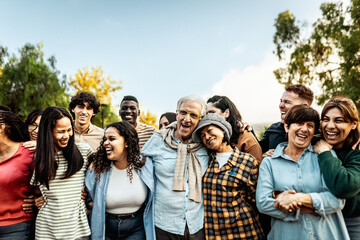 Happy multigenerational people having fun together in a public park - Diversity concept