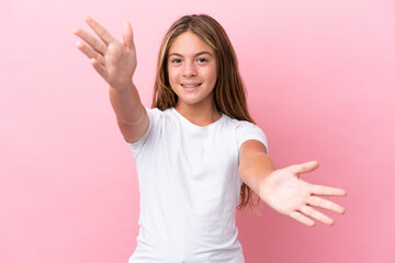 Wall Mural - Little caucasian girl isolated on pink background presenting and inviting to come with hand