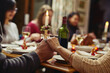 © Viglietti/peopleimages.com - Family, people holding hands in prayer and at dinner table with champagne. Praying for food, support or love and adults gather for celebration or thanksgiving in dining room at their home.