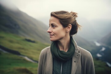 Wall Mural - Portrait of a beautiful young woman in the mountains on a foggy day