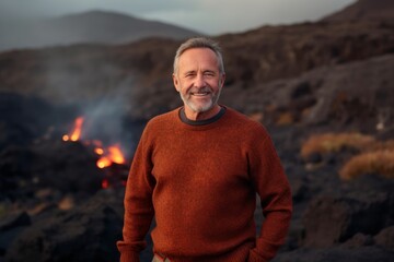 Sticker - Medium shot portrait photography of a pleased man in his 50s wearing a cozy sweater against a volcano or lava background. Generative AI