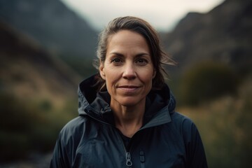 Portrait of a mature woman with a beautiful smile in the mountains