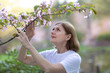 © ulianna19970 - beautiful woman closeup photo in Japanese summer garden with sakura blossom