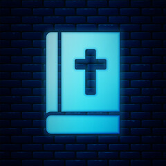 Wall Mural - Glowing neon Holy bible book icon isolated on brick wall background. Vector