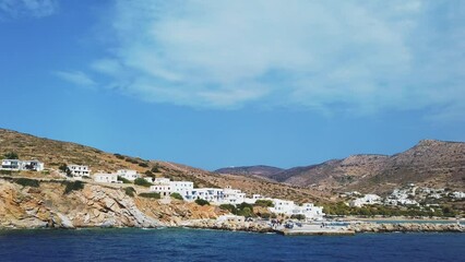 Wall Mural - View of the harbor of Sikinos Island. Traditional white building on the hills.