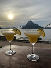 Two Lime Margarita Cocktails On A Table At Sunset,  El Nido, Palawan, Mimaropa, Luzon, Philippines