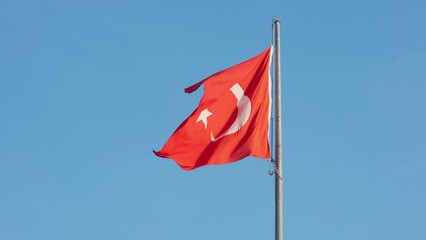 Wall Mural - 4k, Slow motion, The Turkish flag is fluttering in the wind, against the blue sky, close-up