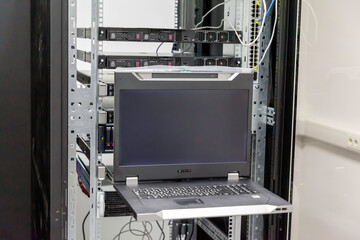 Fototapete - Datacenter server console. Information display in Datacenter server room. Installation of server hardware in the network computer rack and monitor of hardware's work.