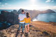 © Michael - Back view of a young tourist couple enjoying the coastal landscape of Madeira Island in the Atlantic Ocean in the morning. São Lourenço, Madeira Island, Portugal, Europe.