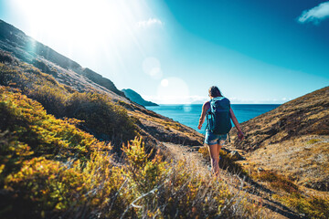 tourist walking down a path to the beach overlooking the coastal landscape of madeira island and the