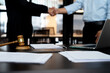 © sabthai - businessman lawyer standing handshake congratulating agreement