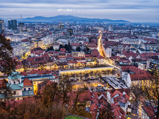 Wall Mural - Aerial long exposure shot of Ljubljana city lit up at dusk during Christmas, Slovenia