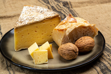 Pieces of cheese tomme de montagne or tomme de savoie made from cow milk in French Alps close up