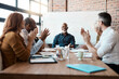 © Viglietti/peopleimages.com - Business people, meeting and applause of black man in office for congratulations, goals or target. Happy, group clapping and senior African male professional with employees in celebration of success.