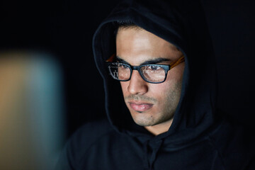 Poster - Hacking, computer and hacker man in hoodie programming, coding software and information technology in dark room. Code analysis, night cybersecurity and programmer or focus person hacking data on pc
