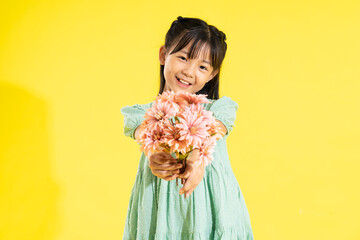 Wall Mural - happy smiling asian girl on yellow background