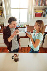 Poster - Laugh, coffee or happy couple speaking in kitchen at home bonding or enjoying quality morning time together. Funny, above or mature man talking, relaxing and drinking espresso tea with woman at home