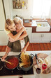 © GR/peopleimages.com - Hug, woman or portrait of happy mother cooking food in healthy diet meal together with love at home. Family, embrace or adult child hugging or helping senior mom in house kitchen for lunch or dinner