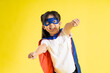 © 1112000 - Portrait of little girl dressed up as a hero, isolated on yellow background