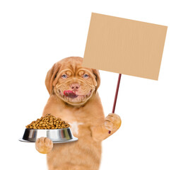 Wall Mural - Licking lips Mastiff puppy holds bowl of dry dog food and shows empty placard. isolated on white background