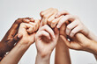 © Nola V/peopleimages.com - People, group diversity and holding hands isolated on a white background for solidarity, support and collaboration. Love, power and community of women and men hand or palm together for hope or care