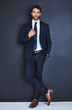 © Lerato Maleswena/peopleimages.com - Portrait, fashion and a formal business man in studio on a blue background for contemporary corporate style. Success, professional and a confident young male employee in a suit for executive power