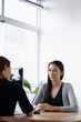 © N Katie/peopleimages.com - Documents, job interview and business women in office for conversation, talking and discussion at desk. Meeting, partnership and female workers with paperwork for consulting, hiring and recruitment
