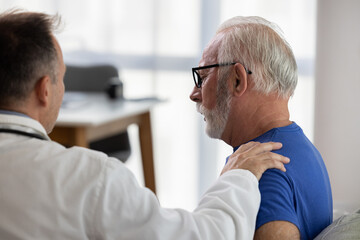 Doctor comforting and supporting sad senior patient having bad diagnosis, disease or health problem. Empathy consoling concept at medical consultation