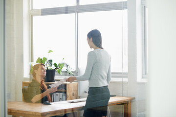 Aufkleber - Documents, resignation letter and business women in office for quitting, termination and unemployment note. Corporate, discussion and female worker giving manager paperwork to resign in workplace