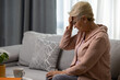 Senior woman suffering from headache at home. Healthcare, pain, stress, age and people concept