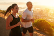 Sunrise, training and running couple as workout or morning exercise for health and wellness together. Sport, athlete and woman runner run with man as fitness in a city for sports or energy