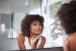 © Mapodile M/peopleimages.com - Woman, skincare and bathroom mirror face check after cosmetic, treatment and cleaning in her home. Beauty, glow and female touching her skin after facial, grooming and smile with results satisfaction