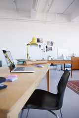 Poster - Empty office, startup or laptop on wooden table in workplace, company or workspace for business. Background, modern interior design or closeup of furniture with nobody or chair in digital agency