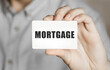© MP Studio - Card with text mortgage in a man's hand