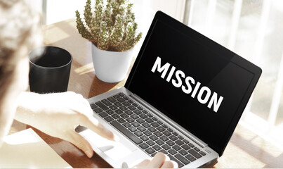 Poster - Businessman typing text Mission in laptop on office background