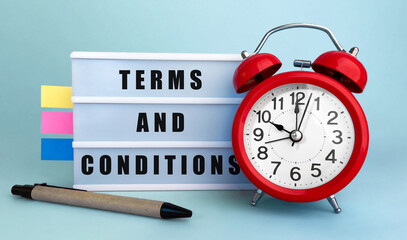 Aufkleber - Text Terms and conditions written on the lightbox with alarm clock and colorfull stickers on blue background