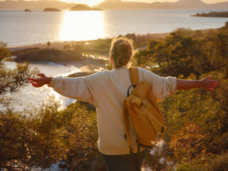 Travel and active lifestyle concept. Happy smiling woman hiking in mountains , Fethie, Turkey. Young female hiker smiling, sport and trekking in autumn or spring nature.