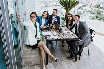 Wall Mural - Group of latin business people or teamwork taking a photo selfie portrait at office in Mexico Latin America, hispanic people	working in job