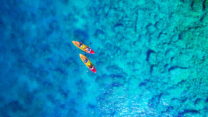 Wall Mural - kayaking. aerial view of floating kayaks and people on blue sea at sunny day. travel and active life