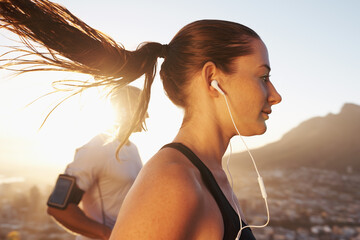 Canvas Print - Sunrise, streaming and woman running as exercise or morning workout for health and wellness together. Sport, man and runner run with athlete while training and listening to sports music for energy