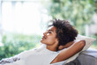 © Mapodile M/peopleimages.com - Relax, smile and black woman on sofa sleeping, afternoon nap and rest in calm apartment on weekend. Sleep, daydream ideas and girl on couch relaxing, self care and stress free chill time in lounge.