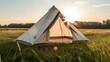 Camping tent in the meadow at sunset.. Generative AI