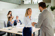 © BGStock72 - Young business woman handshaking with his colleague in the office